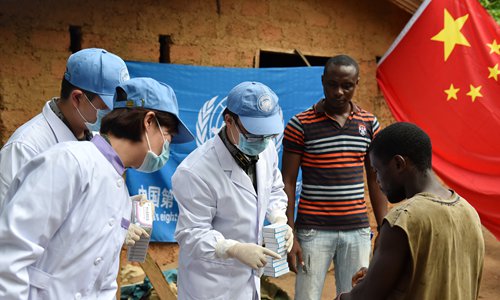 A Chinese team distributes medicine to local residents in Liberia in November 2015. Photo: Xinhua