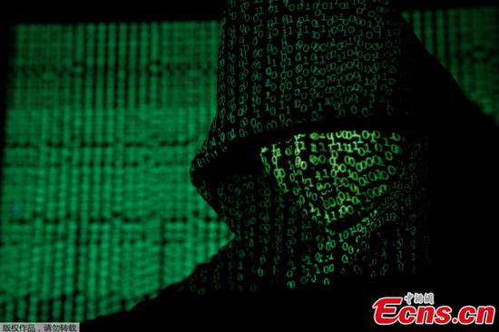 A projection of cyber code on a hooded man is pictured in this illustration picture taken on May 13, 2017. (Photo: Kacper Pempel/Illustration/File Photo/REUTERS)