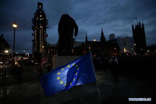 EU and UK flags are seen outside the Houses of Parliament, in front of a statue of Winston Churchill, in London, Britain on Jan. 15. 2019. The British parliament on Tuesday rejected overwhelmingly the Brexit deal, further complicating the country's historic exit from the European Union (EU). (Xinhua/Tim Ireland)