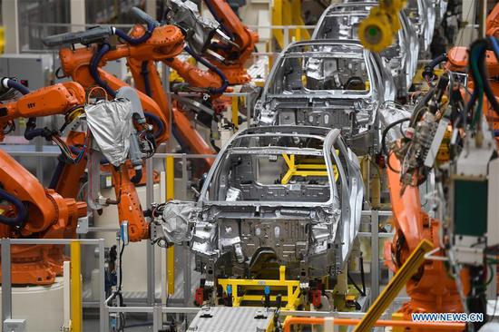 Robotic arms are busy working on the assembly line in Geely Auto factory in Ningbo, east China's Zhejiang Province, Oct. 25, 2018. (Xinhua/Huang Zongzhi)