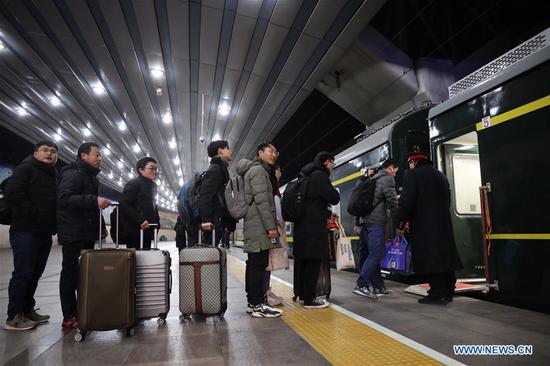 Passengers prepare to board the train K4051 to Nantong City in east China's Jiangsu Province, at the Beijing Railway Station in Beijing, capital of China, Jan. 21, 2019, the first day of the 2019 Spring Festival travel rush. Hundreds of millions of Chinese return to their hometowns every year for the Lunar New Year, or Spring Festival, family reunions, thus forming the Spring Festival travel rush. The Spring Festival, or the Year of the Pig in the Chinese lunar calendar, will begin on Feb. 5 this year. The 40-day 2019 Spring Festival travel rush started on Jan. 21, with 3 billion trips expected to be made. (Xinhua/Xing Guangli)