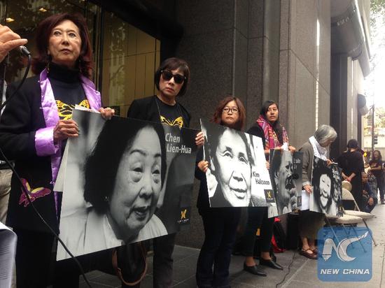 File Photo: Representatives of grassroots community organizations hold pictures of 