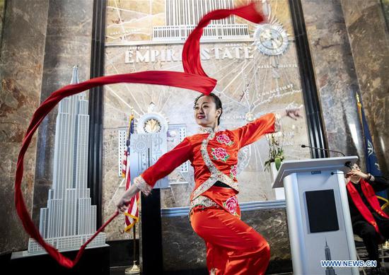 A dancer performs during the lighting ceremony for Chinese Spring Festival at the Empire State Building in Manhattan, New York, the United States, on Feb. 1, 2019. The top of the landmark Empire State Building in Manhattan will shine in red, blue and yellow on the nights of next Monday and Tuesday to celebrate the Chinese New Year, which falls on Feb. 5 this year. (Xinhua/Wang Ying)