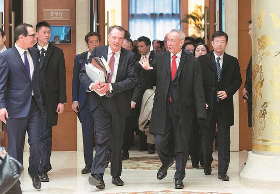 Vice-Premier Liu He, US Trade Representative Robert Lighthizer (center front) and US Treasury Secretary Steven Mnuchin (left) walk out of venue that was host to a new round of high-level economic and trade consultations in Beijing on Thursday. (Photo/Xinhua)