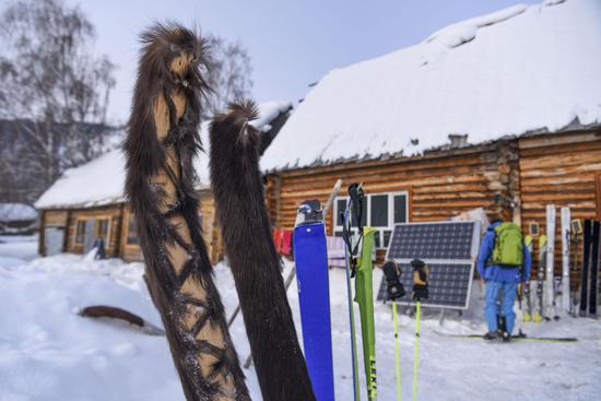 Skiers place their snowboards outdoors before taking a rest. (Xinhua/Hu Huhu)