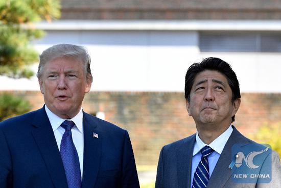 File Photo: U.S. President Donald Trump (L) meets with Japanese Prime Minister Shinzo Abe upon his arrival at the Kasumigaseki Country Club in Kawagoe, near Tokyo, Japan, Nov. 5, 2017.(Xinhua)