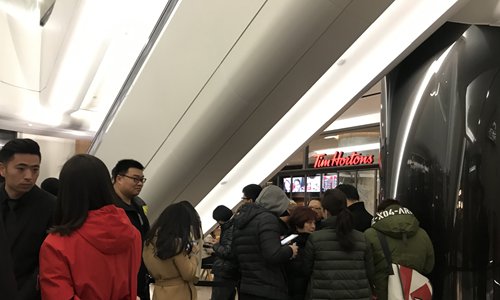 Consumers wait in line to buy coffee from Tim Hortons' first store in the Chinese mainland in Shanghai on Tuesday. (Photo: Xie Jun/GT)