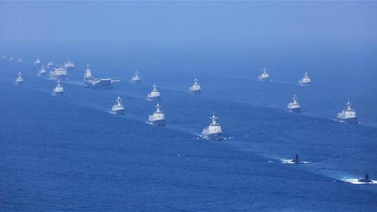 Vessels and aircraft including the aircraft carrier Liaoning and latest submarines, vessels and fighter jets take part in a review in the South China Sea on April 12, 2018. /Xinhua Photo