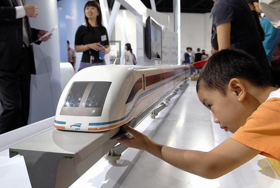 A boy checks out a model maglev train at a science and technology fair hosted by thyssenkrupp in Shanghai. (Photo provided to China Daily)