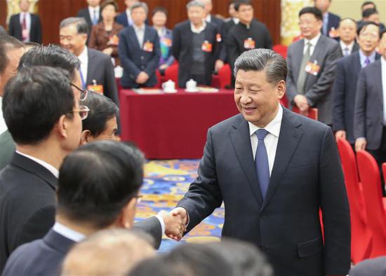 Xi Jinping, general secretary of the Communist Party of China Central Committee, president, and chairman of the Central Military Commission, makes a visit in Beijing on Monday to political advisers from the sectors of culture, art and social sciences who are attending the second session of the 13th National Committee of the Chinese People’s Political Consultative Conference. (Photo/Xinhua)