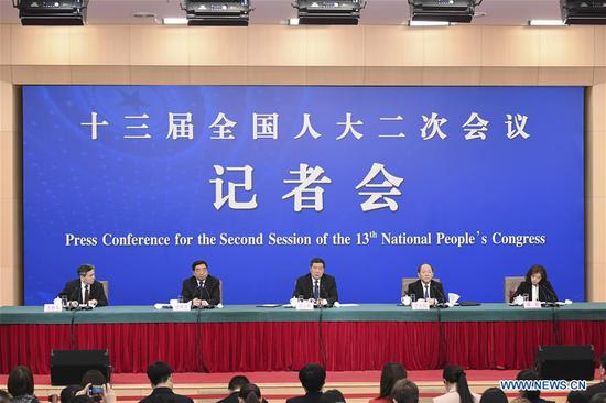He Lifeng (C), head of the National Development and Reform Commission, Ning Jizhe (2nd R) and Lian Weiliang (2nd L), both deputy heads of the commission, attend a press conference on advancing the high-quality development of China's economy for the second session of the 13th National People's Congress in Beijing, capital of China, March 6, 2019. (Xinhua/Zhai Jianlan)