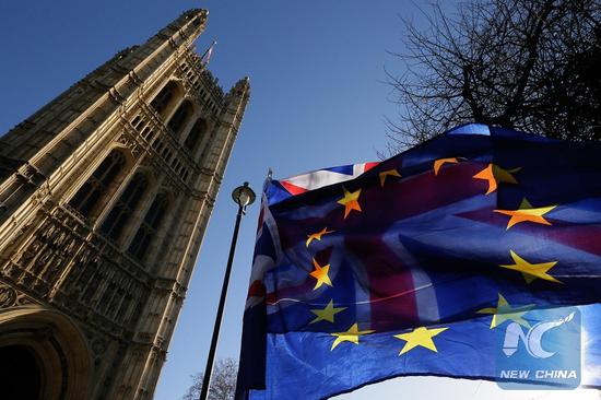 An EU flag is seen in front of a UK flag outside the Houses of Parliament in London, Britain, on Jan. 17, 2019. (Xinhua/Tim Ireland)