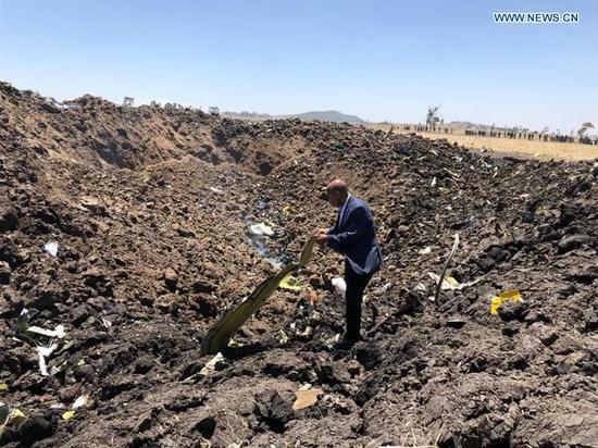 A man checks the wreckage of the airplane of Ethiopian Airlines (ET) which crashed earlier near Bishoftu city, about 45 kms southeast of Addis Ababa, Ethiopia, March 10, 2019. All 149 passengers and eight crew members aboard ET 302, bound for Nairobi, Kenya, are confirmed killed, the Ethiopian Broadcasting Corporation (EBC) said. (Xinhua/Ethiopian Airlines)