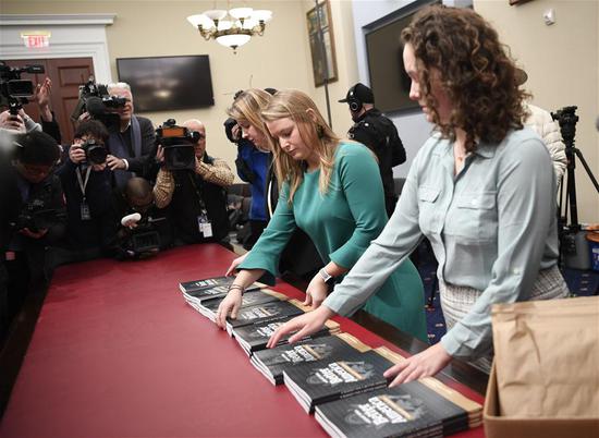 Workers prepare the copies of Volume 1 of U.S. President Donald Trump's budget for Fiscal Year 2020 on Capitol Hill in Washington D.C., the United States, on March 11, 2019. U.S. President Donald Trump presented to Congress on Monday a budget proposal for fiscal year 2020 that contained stiff spending cuts across non-defense federal agencies, and a hike in defense money. (Xinhua/Liu Jie)