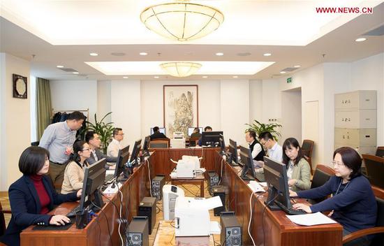 Staff members of the secretariat of the second session of the 13th National People's Congress (NPC) work in Beijing, capital of China, March 12, 2019. Deputies to the 13th NPC have filed 491 proposals and around 8,000 items of suggestions to the secretariat of the legislative body's second annual session. (Xinhua/Jin Liwang)