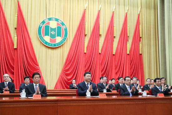 Chinese President Xi Jinping and other Communist Party of China and state leaders Li Keqiang, Li Zhanshu and Wang Huning attend the opening ceremony of the eighth congress of the China Law Society and extend their congratulations to the congress in Beijing, capital of China, March 19, 2019. (Xinhua/Ju Peng)