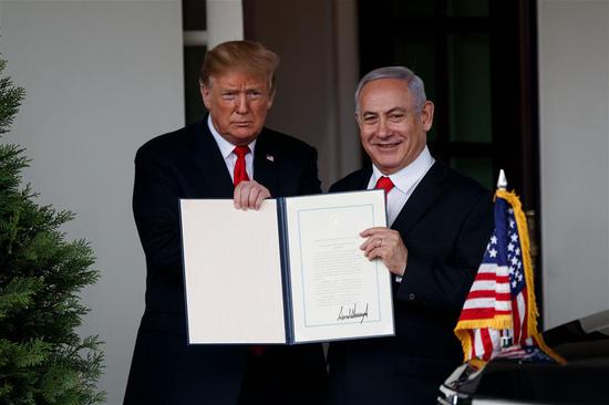 U.S. President Donald Trump (L) and Israeli Prime Minister Benjamin Netanyahu display the proclamation recognizing Israel's sovereignty over the disputed Golan Heights at the White House in Washington D.C., the United States, on March 25, 2019. U.S. President Donald Trump on Monday signed a proclamation recognizing Israel's sovereignty over the disputed Golan Heights, territory that Israel seized from Syria in 1967. (Xinhua/Ting Shen)