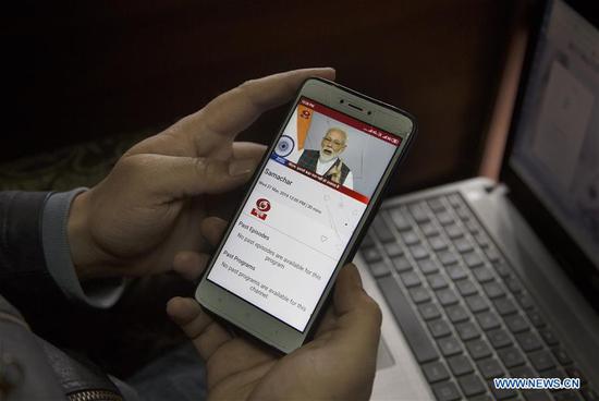A man watches Indian Prime Minister Narendra Modi's address on his mobile phone in Srinagar, the summer capital of Indian-controlled Kashmir, March 27, 2019. Indian Prime Minister Narendra Modi Wednesday in a surprise address to the nation claimed Indian scientists shot down a live satellite on a low earth orbit (LEO) with an anti-satellite weapon A-SAT. (Xinhua/Javed Dar)