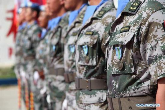 File photo: Chinese peacekeepers wearing the United Nations Peace Medal of Honor are seen at the awarding ceremony at the camp of the Chinese peacekeeping multi-functional engineer detachment to Lebanon in Hanniyah village in southern Lebanon, on April 6, 2018. [File photo: Xinhua]