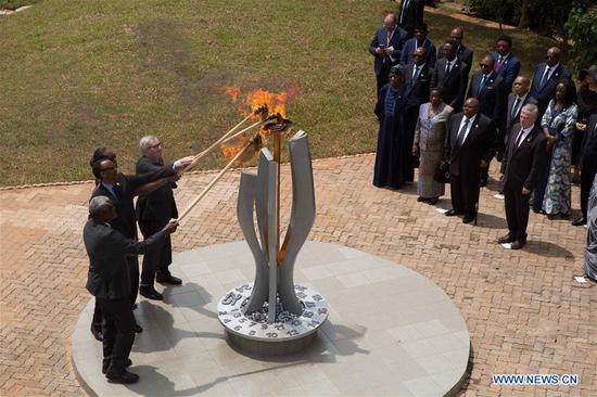 Rwandan President Paul Kagame, his wife Jeannette Kagame, African Union Commission Chairperson Moussa Faki Mahamat and President of the European Commission Jean-Claude Juncker light the flame of remembrance at the Kigali Genocide Memorial during the commemoration marking the 25th anniversary of the 1994 Rwandan genocide against Tutsi in Kigali, capital of Rwanda, April 7, 2019. (Xinhua/Gabriel Dusabe)