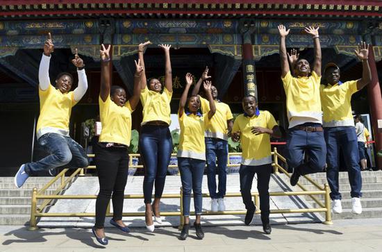 File photo: African students, who work as volunteers at Yuanmingyuan, or the Old Summer Palace, jump in unison for a group photo in Beijing.  (Photo/Xinhua) 