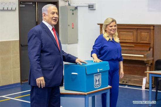 Israeli Prime Minister Benjamin Netanyahu (L) casts his ballot at a polling station in Jerusalem, April 9, 2019. Israel on Tuesday morning started day-long general elections across the country to choose its next parliament and decide the premiership. (Xinhua/JINI/Emil Salman)