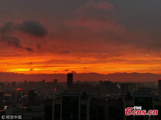Brilliant sunset silhouettes city skyline