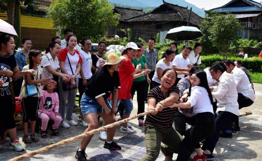 Members of staff join in a tug-of-war in Congjiang county, Guizhou province. (Luo Jinglai / For China Daily)