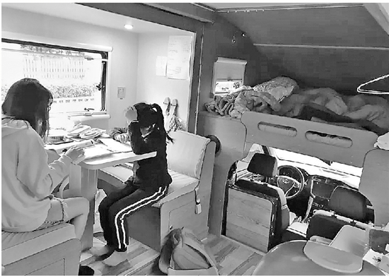 A little girl studies in a motorhome her parents have bought to ease her schooling. (Photo/Qianjiang Evening News)
