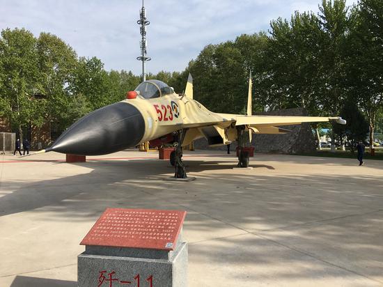 A J-11 fighter jet is on display at the exhibition park that opened to the public on Sunday in Xi'an, Northwest China's Shaanxi province. (Photo by Zhao Lei/chinadaily.com.cn)