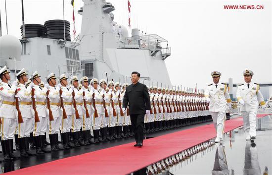 Chinese President and Central Military Commission Chairman Xi Jinping inspects the honor guards of the Chinese People's Liberation Army (PLA) Navy before boarding the destroyer Xining at a pier in Qingdao, east China's Shandong Province, on April 23, 2019. (Xinhua/Li Gang)