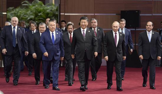 President Xi Jinping and foreign leaders enter the hall for the opening ceremony of the Second Belt and Road Forum for International Cooperation in Beijing on Friday. (LI XUEREN / XINHUA)