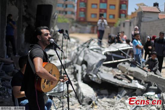 Palestinian singers perform on rubble of bombed out building in Gaza