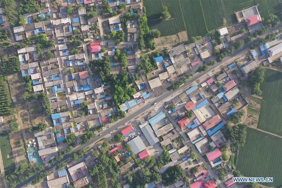 Aerial photo taken on May 14, 2019 shows the view of Gongzhuang Village of Bayu Township, Rongcheng County, Xiongan New Area, north China's Hebei Province. Relocation has officially started in Xiongan New Area, a new city in the making about 100 kilometers southwest of Beijing. A large-scale building phase will start this year at Xiongan, authorities said. A 13-sq-km residential area will be built in the east part of Rongcheng County. (Xinhua/Xing Guangli)