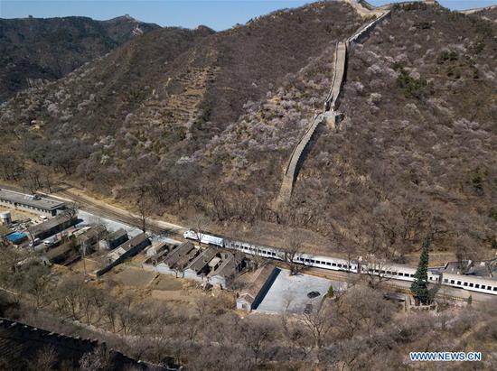 In this aerial photo taken on April 2, 2019, a Line S2 train of Beijing Suburban Railway (BSR) pulls out of Qinglongqiao station of the Beijing-Zhangjiakou railway in Beijing, capital of China. (Xinhua/Ju Huanzong)