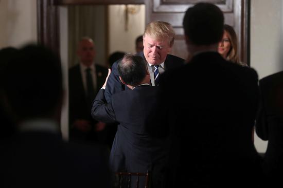 U.S. President Donald Trump greets SoftBank CEO Masayoshi Son as he attends a Japanese business leaders event in Tokyo, Japan, May 25, 2019. (Photo/Agencies)