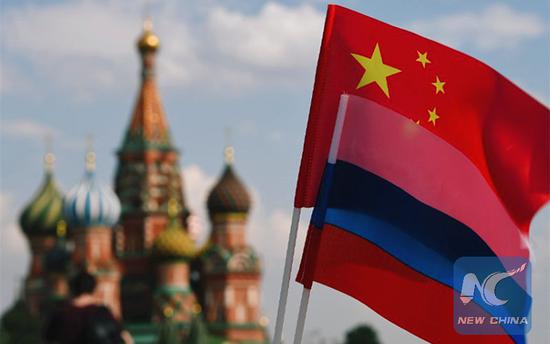 National flags of China and Russia are seen in the Red Square, Moscow, Russia.