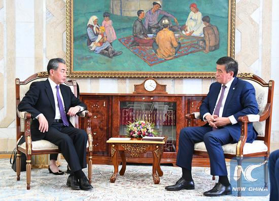 Kyrgyz President Sooronbay Jeenbekov (R) meets with Chinese State Councilor and Foreign Minister Wang Yi in Bishkek, Kyrgyzstan, May 21, 2019.