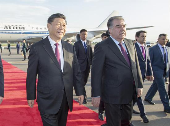 Chinese President Xi Jinping (L) is warmly received by Tajik President Emomali Rahmon upon his arrival at the airport in Dushanbe, Tajikistan, June 14, 2019. Xi arrived here Friday for the fifth summit of the Conference on Interaction and Confidence Building Measures in Asia (CICA) and a state visit to Tajikistan. (Xinhua/Xie Huanchi)