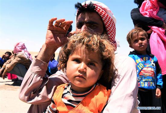Syrian refugees arrive at the Jlaighem crossing in the eastern countryside of Homs Province, Syria, on June 19, 2019.  (Xinhua/Ammar Safarjalani)