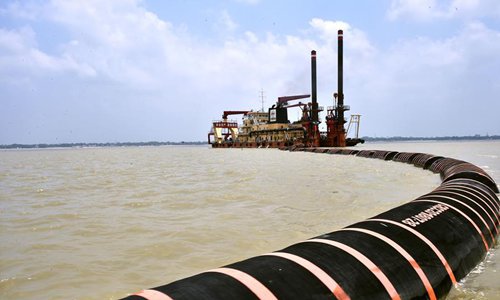 A dredging machine of CRCC Harbour and Channel Engineering Bureau Group Co., Ltd. spews muddy water after extraction from a channel of Padma river in Shariatpur, Bangladesh on May 27, 2019. (Xinhua/Stringer)