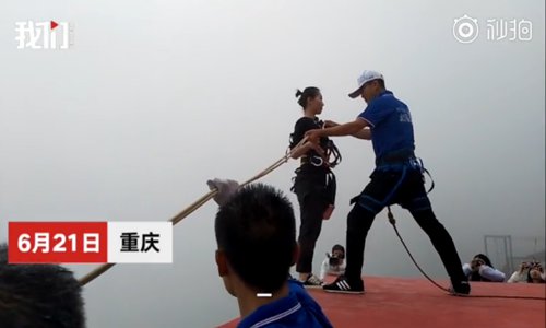 Wan Tiandi, a meal delivery woman in a mountain scenic area in Southwest China's Chongqing Municipality jumps from a 300-meter-high cliff every day to send hot meals to her colleagues at the foot of the mountain. (Photo/Screenshot of the video by The Beijing News)