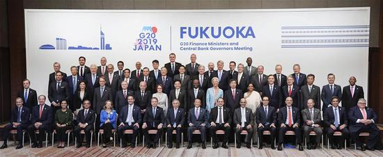 Representatives attending the Group of 20 Finance Ministers and Central Bank Governors Meeting pose for a group photo in Fukuoka, Japan, June 9, 2019. Finance ministers and central bank governors from the Group of 20 economies on Sunday issued a joint statement in the Japanese city of Fukuoka after a two-day meeting on trade and digital economy. (Xinhua/Kyodo)