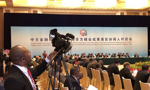 A photographer at the site of the Dialogue between Executives of Chinese Financial Institutions and African Coordinators of the Implementation of the Follow-up Actions of the Beijing Summit of FOCAC in Beijing on Monday. (Photo: Chu Daye/GT)