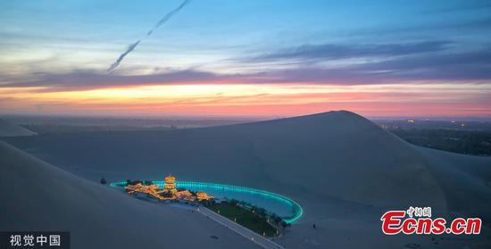 Dunhuang city in Northwest China's Gansu province, is brightened by stars when the nights falls in May, 2019. (Photo/VCG)