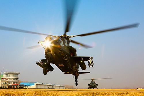 A Z-10 attack helicopter attached to an army aviation brigade under the PLA 80th Group Army hovers at low altitude for last-minute checks during the flight training on November 21, 2017. （Photo/eng.chinamil.com.cn）