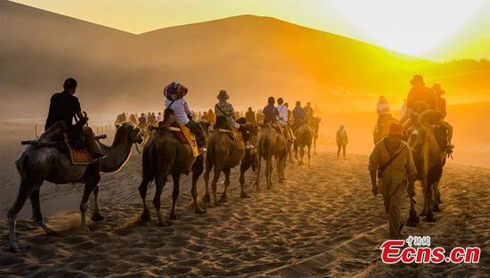 Camel riding a popular choice for tourists to Dunhuang