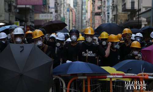 Protesters refuse to disperse near the area around the liaison office of the Central People's Government in Hong Kong on July 28 and continued provoking police officers, using various articles like laser pointers, batons and umbrellas. (Photo/Global Times )