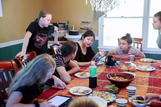 Daughters of Lynn Berat talk with their Chinese teacher Lin (3rd R) at Lin's house in Bernards of New Jersey, the United States, July 13, 2019.