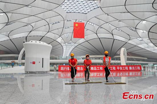 Workers debug devices at the terminal building of Beijing Daxing International Airport in Beijing, capital of China, June 19, 2019.  (Photo: China News Service)